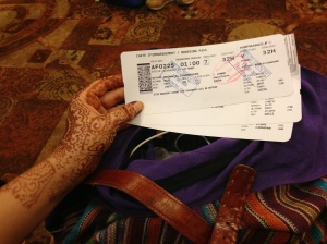 A photo of me holding my 3 boarding passes to get back to the USA.